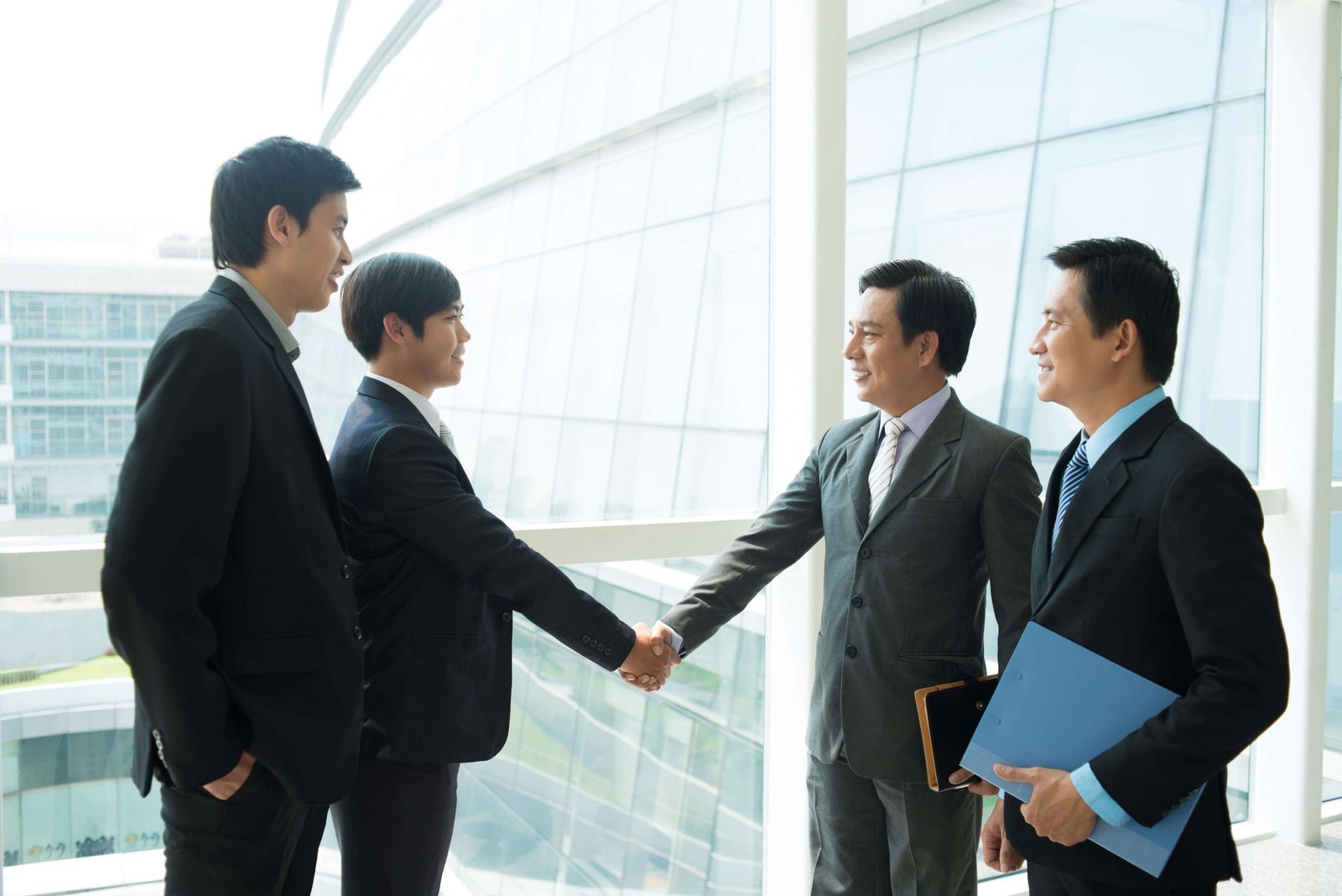 image-of-business-partners-handshaking-inside-on-the-foreground-SBI-325537205-min
